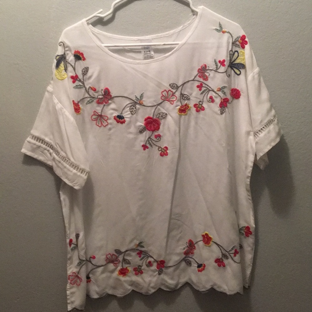 White embroidered top with scalloped bottom.